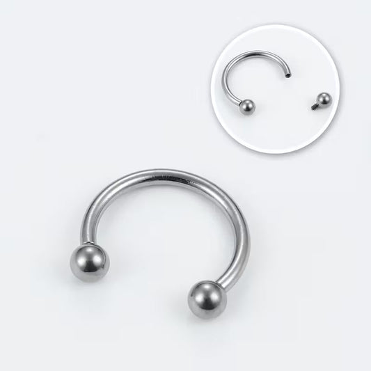Silver-colored C-shaped circular barbell with two ball ends; inset shows one detached ball and its screw connection